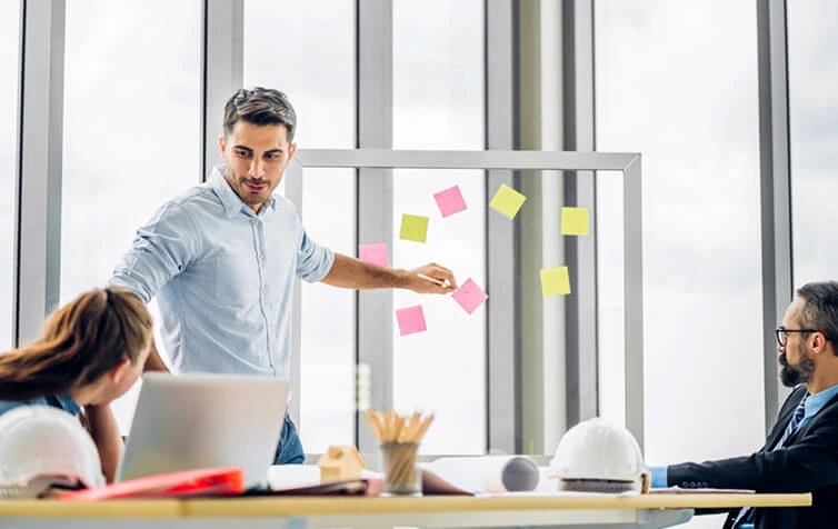A man leads an SEO services meeting with colleagues at a digital marketing agency.