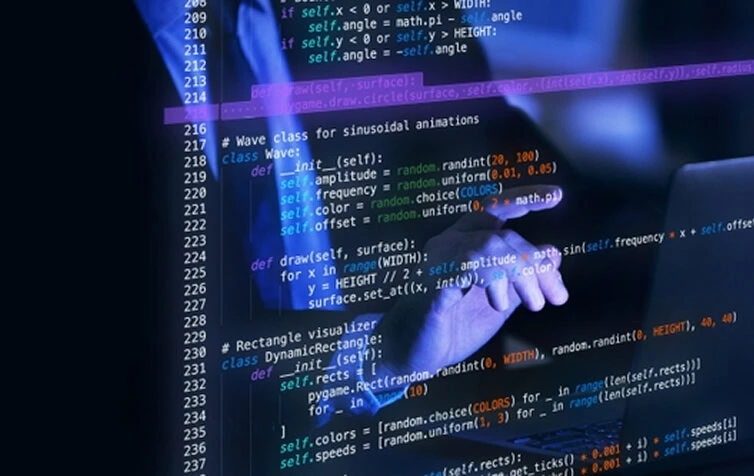 A person points at code for animations and web development on a screen, highlighting digital marketing and SEO services.