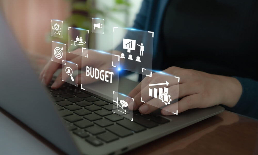 Digital marketing agency professional typing on laptop with SEO, analytics, and web development icons.