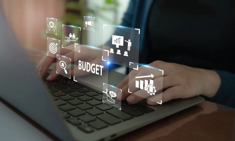 Digital marketing agency professional typing on laptop with SEO, analytics, and web development icons.