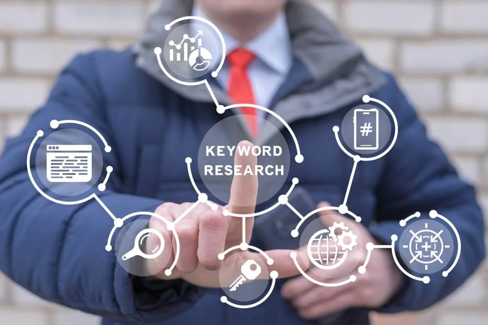 A marketing professional in a suit points at a digital interface with "Keyword Research," SEO services, and digital marketing agency icons.