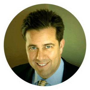 Dr. Jonathan Calure, digital marketing expert, smiles in a professional agency headshot.