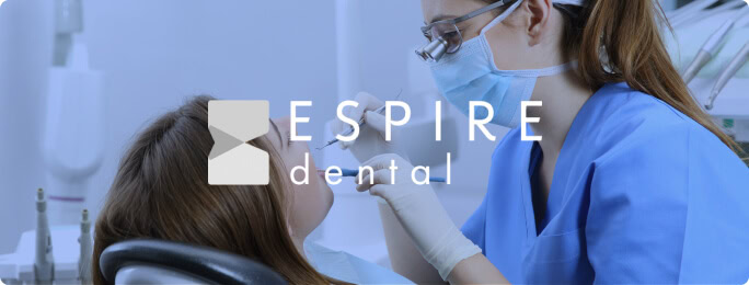A dental professional examines a patient, showcasing dental SEO services and web development; "ESPIRE dental" appears on the image.