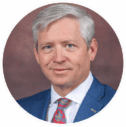 Portrait of a middle-aged man in a blue suit, representing a digital marketing agency leader.