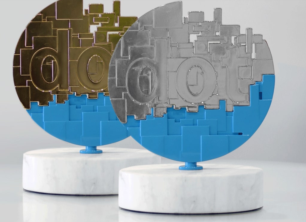Two abstract dotCOMM Award trophies celebrate Intellibright, a top digital marketing agency.