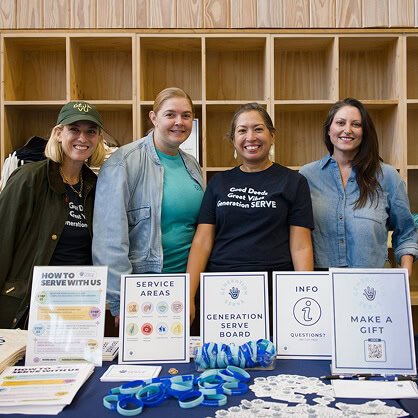 Four women at a digital marketing agency booth promote SEO, paid media, and content marketing.