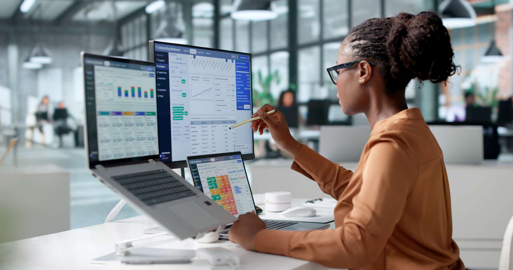 Digital marketing agency professional analyzing insurance data on monitors.