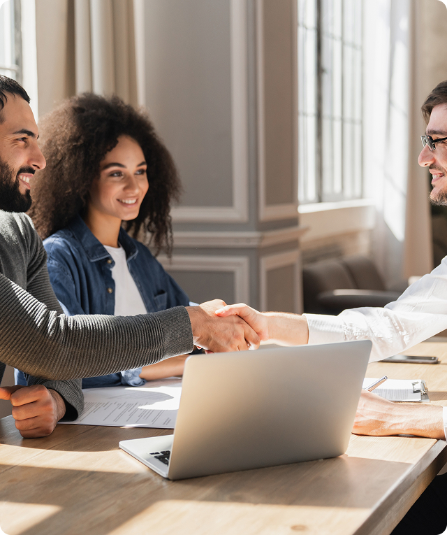 Digital marketing agency experts discuss mortgage solutions over a laptop.